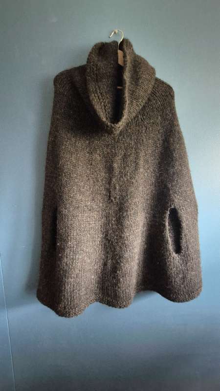 Dark wool poncho with high neck