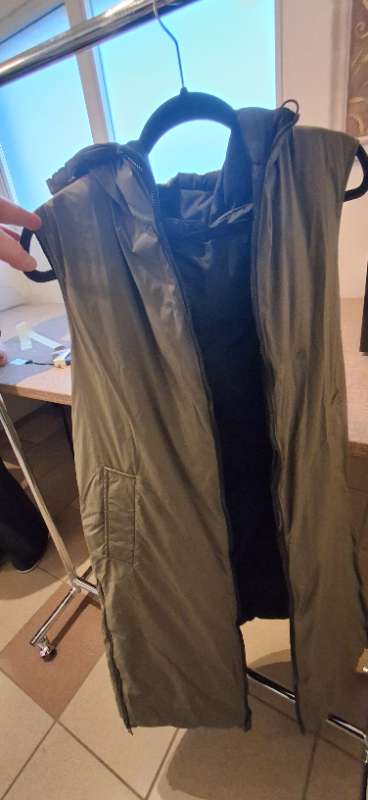 Reversible green and black sleeveless coat